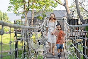 Asian mother and her som running togather on the garden