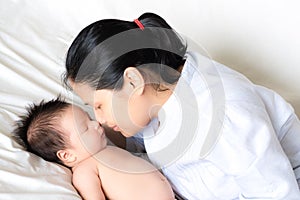 Asian mother holds her newborn baby