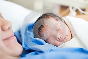 Asian mother with newborn baby in the hospital