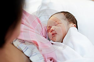 Asian mother with newborn baby in the hospital