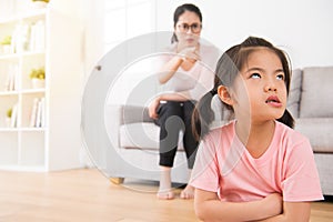 Asian mother sitting on the sofa angry pointing