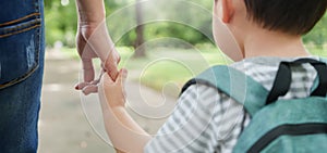 Asian Mother and son holding hands walking