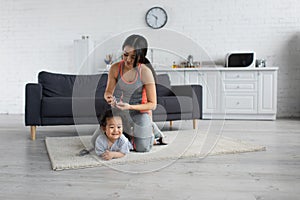 Asian mother in sportswear holding barrette