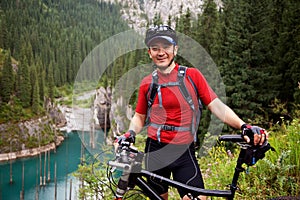 Asian mountain biker and lake