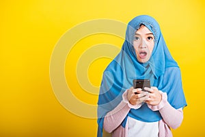 Asian Muslim Arab woman Islam wear hijab she reads surprised confused shock news open mouth