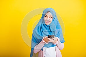 Asian Muslim Arab woman Islam wear hijab smile she using hold mobile smart phone