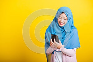 Asian Muslim Arab woman Islam wear hijab smile she using hold mobile smart phone