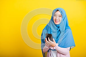 Asian Muslim Arab woman Islam wear hijab smile she using hold mobile smart phone