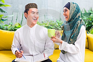 Asian Muslim couple drinking coffee or tea