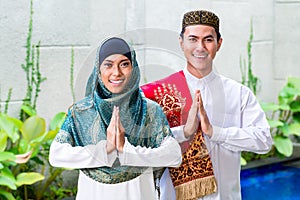 Asian Muslim couple wearing traditional dress