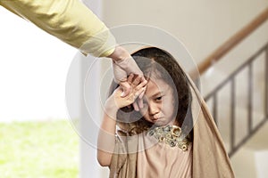 Asian muslim girl kissing hand parents as respect