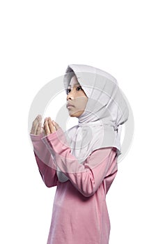 Asian muslim girl wearing veil and praying to god