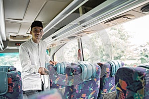 asian muslim man doing eid mubarak traveling back to his hometown by riding a bus
