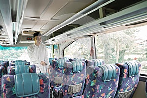 asian muslim man doing eid mubarak traveling back to his hometown by riding a bus