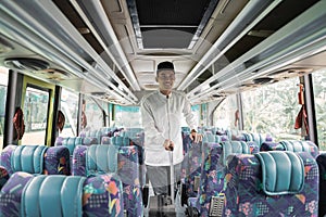 asian muslim man doing eid mubarak traveling back to his hometown by riding a bus