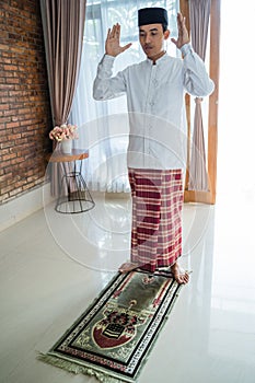 Asian muslim man solat and takbir