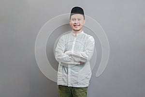 Asian Muslim man standing with crossed arm