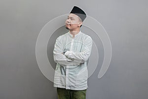 Asian Muslim man standing with crossed arm