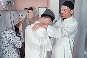 Asian muslim parent shake hand in idul fitri eid mubarak