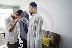 Asian muslim parent shake hand in idul fitri eid mubarak