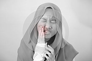 Asian muslim teenage girl suffering from toothache pain