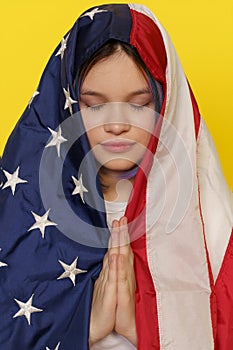 Asian Muslim Teenager Girl Using American Flag As Hijab, Combining Elements Of American And Islamic Identity. Against