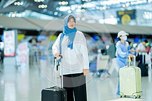 An Asian Muslim wearing a blue hijab is preparing for a vacation and she is at the airport.