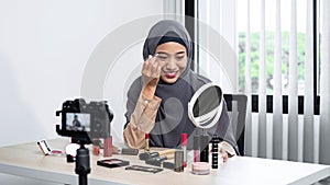 Asian muslim woman beauty blogger tutorial eyebrow techniques and making videos to review cosmetic