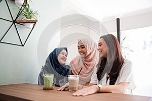 Asian muslim woman bestfriend together in cafe