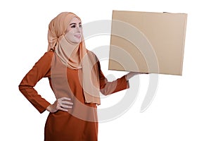 Asian Muslim woman carrying boxes