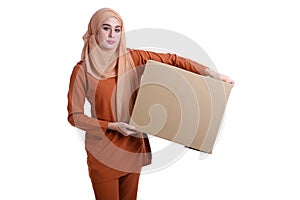 Asian Muslim woman carrying boxes
