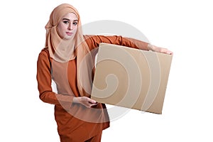 Asian Muslim woman carrying boxes