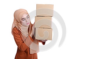 Asian Muslim woman carrying boxes