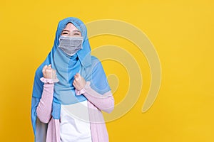 Asian muslim woman in medical mask Coronavirus pandemic disease smiling and greeting isolate background. COVID-19 virus epidemic o