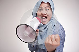 Asian muslim woman Shouting with Megaphone, Leader, Supporter or Protester