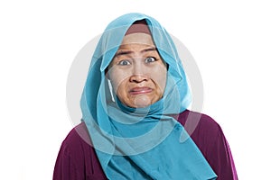 Asian muslim woman wearing hijab showing a ridiculous expression, absurd. Isolated on white