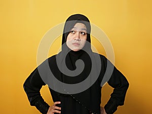 Asian muslim woman wearing hijab shows thinking contemplating expression. Looking for solution of a problem. Close up portrait