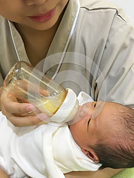 Asian new born baby feeding milk.