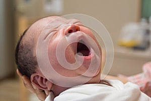 Asian new born baby yawning