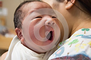 Asian new born baby yawning