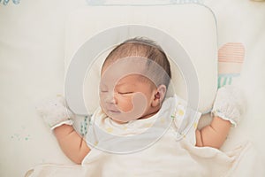 Asian Newborn baby boy in bed. New born child sleeping. Children sleep. Bedding for kids. Infant napping in bed. Healthy little