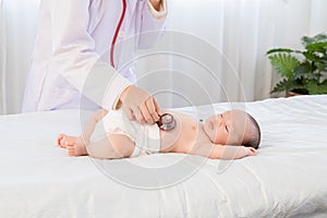 Asian newborn baby get sick sleep during examine by pediatrician doctor hand hold stethoscope, Little child in medicine hospital.