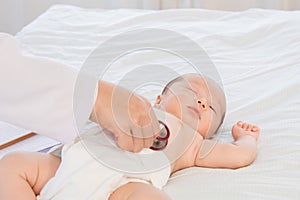 Asian newborn baby get sick sleep during examine by pediatrician doctor hand hold stethoscope, Little child in medicine hospital.