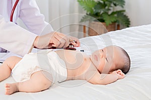 Asian newborn baby get sick sleep during examine by pediatrician doctor hand hold stethoscope, Little child in medicine hospital.