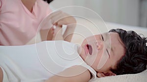 Asian newborn crying lying down on bed with elder sister, infant feel uncomfortable or hungry, adorable girl take care toddler 1-2