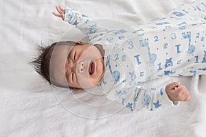 Asian newborn crying on white towel