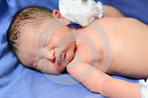 Asian newborn Infant Baby boy on blue blanket with umbilical