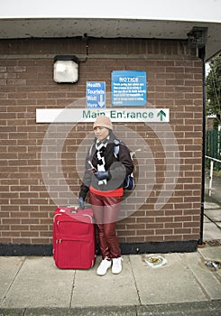 Asian NHS Health Tourist With Sign Above photo