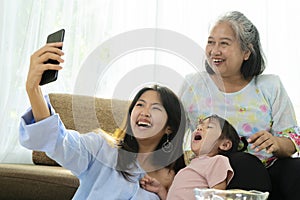 Asian niece and grandma are enjoying taking selfies