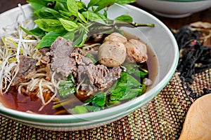 Asian noodle soup with beef meatball with fresh vegetable on woo